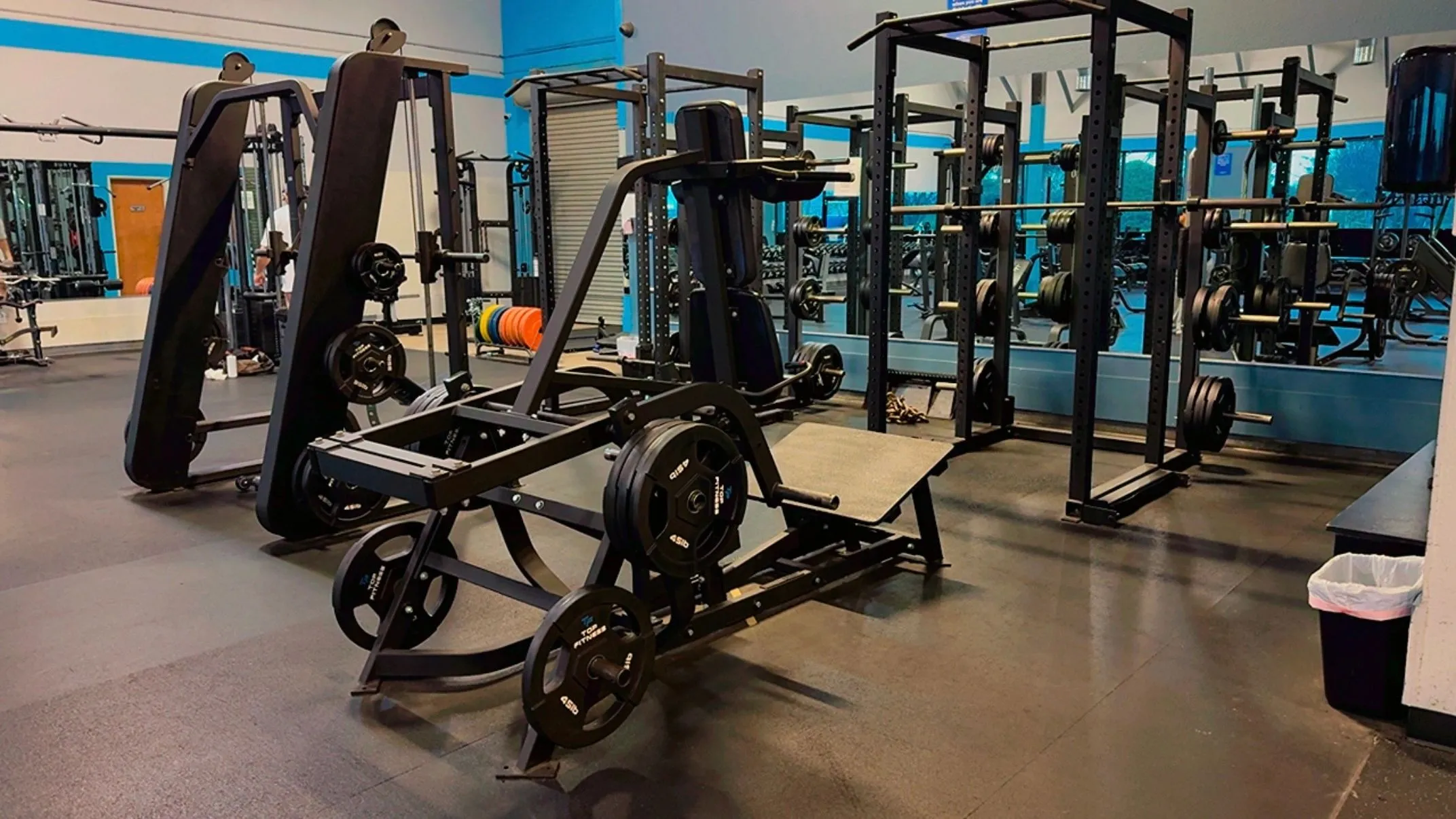 Plate-loaded strength machines and power racks on the Elite Fitness Dixon weight floor