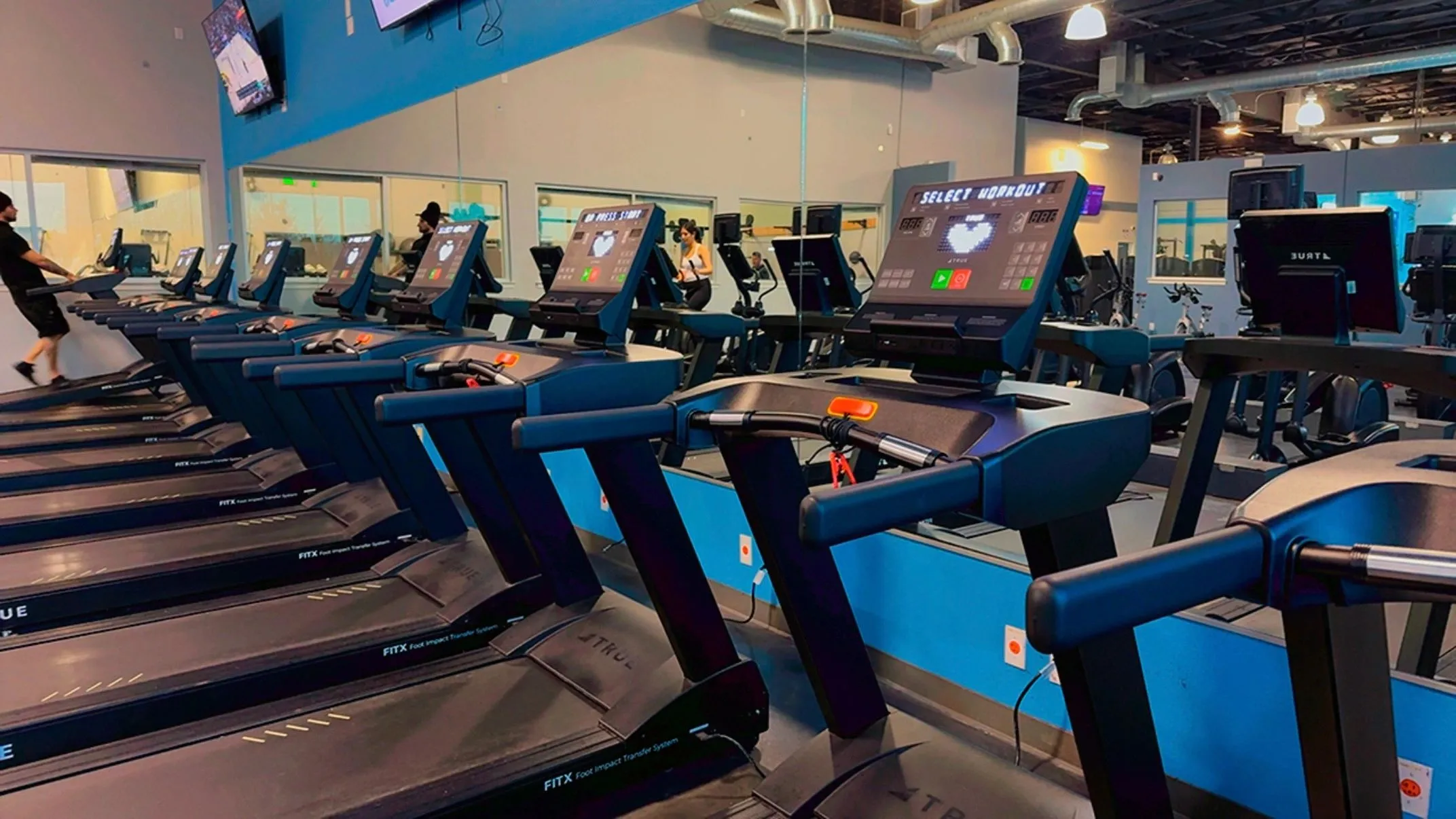 Row of treadmills with screens in the cardio area at Elite Fitness Dixon